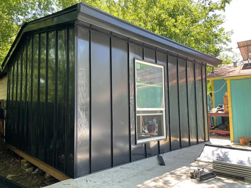 Black standing seam metal wall panels for Roof Inspection in Mineola