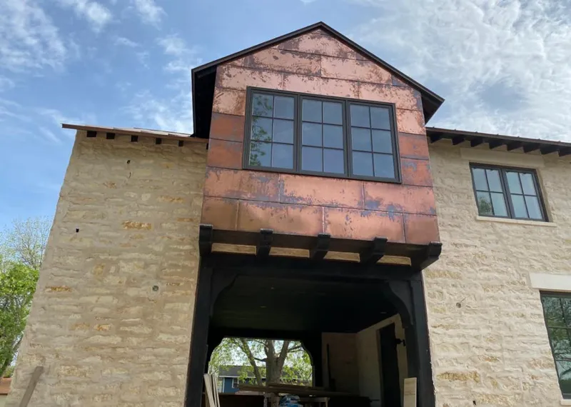 Copper metal panel facade on a stone building for Metal Roof Coating in Mineola