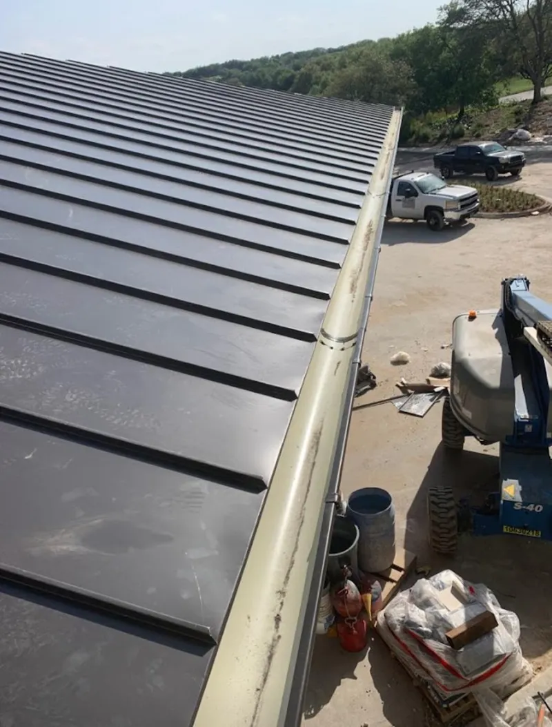 Standing seam panel and gutter detail on a metal roofing jobsite in Mineola